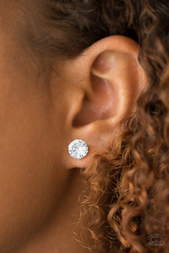 Just In TIMELESS - Gold - Paparazzi Accessories -  P5PO-GDXX-008XX  A sparkling white rhinestone is nestled inside a classic gold frame for a timeless look. Earring attaches to a standard post fitting.  Sold as one pair of post earrings by DeesBlings.com - Affordable Fashion Jewelry that is Lead and Nickel free.