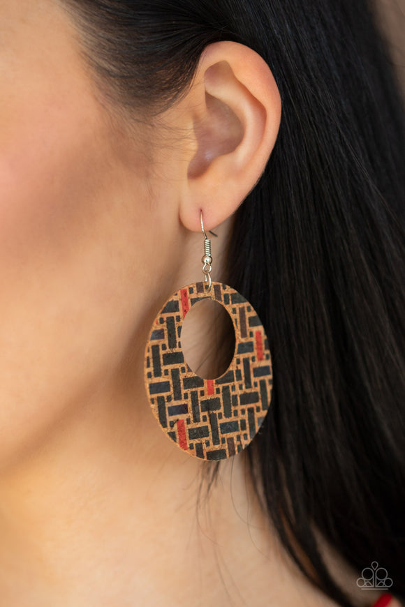 Put A Cork In It - Black - Paparazzi Accessories  Painted in a colorful geometric print, a cork-like hoop swings from the ear in a seasonal fashion. Earring attaches to a standard fishhook fitting.  Sold as one pair of earrings.