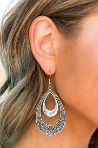 Simply Santa Fe - Sahara Sublime - Silver - Paparazzi Accessories  A polished silver teardrop lays inside the top of larger teardrop frame embossed in winding, dizzying details for a tribal-inspired look. Earring attaches to a standard fishhook fitting.  Sold as one pair of earrings.