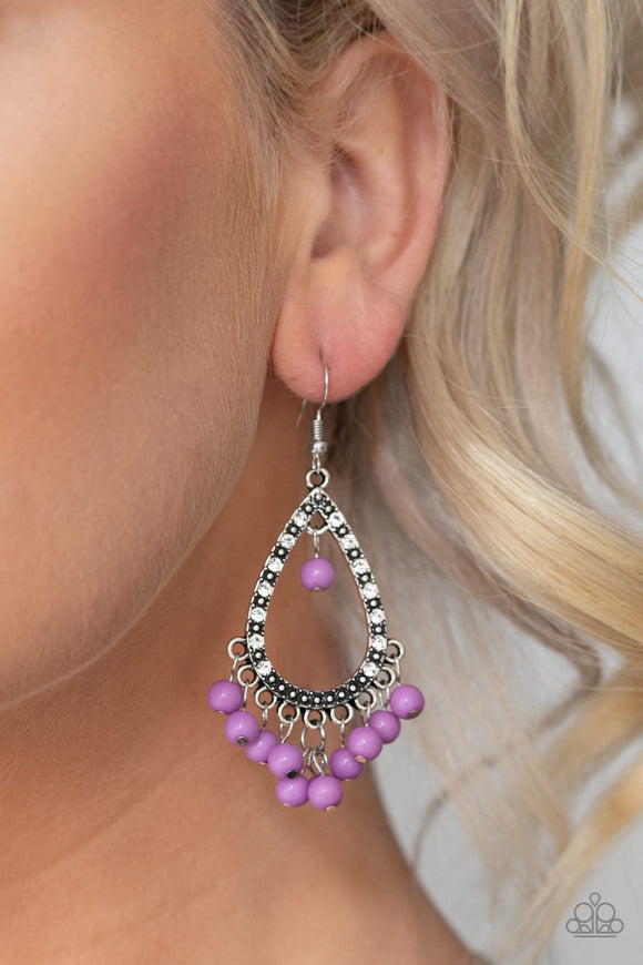 Positively Prismatic - Purple - Paparazzi Accessories  Dainty purple beads dangle from the bottom of a silver teardrop frame encrusted in glassy white rhinestones and silver studs for a colorful look. Earring attaches to a standard fishhook fitting.  Sold as one pair of earrings.