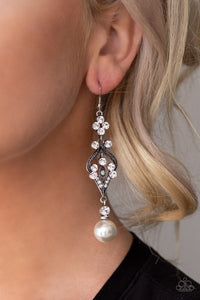 Elegantly Extravagant - White An oversized white pearl dangles from the bottom of a flowery silver frame dotted in sections of glassy white rhinestones for an elegant look. Earring attaches to a standard fishhook fitting.  Sold as one pair of earrings.