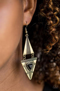 El Paso Edge - Brass - Paparazzi Accessories - P5SE-BRXX-050XX  Stamped in tribal inspired patterns, two triangular frames connect into a bold lure. Chiseled into a matching triangle, an earthy black stone is pressed into the bottom frame for a seasonal finish. Earring attaches to a standard fishhook fitting.  Sold as one pair of earrings.