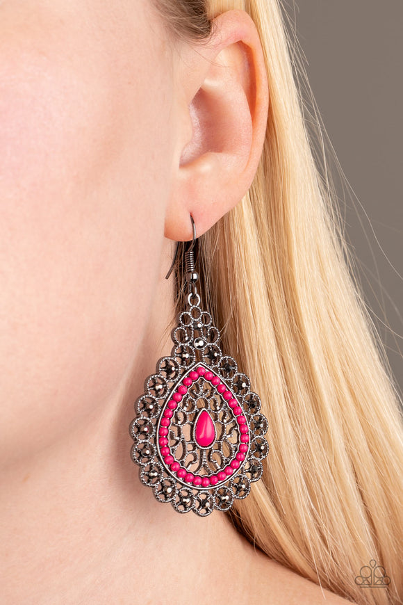 Carnival Courtesan - Pink - Paparazzi Accessories - Item #P5ED-PKXX-026XX Regal gunmetal filigree climbs a teardrop shaped frame, coalescing into a glistening frame. Dainty pink beads adorn the center of the frame, while glittery hematite rhinestones embellish the outer frame for a refined finish. Earring attaches to a standard fishhook fitting.  Sold as one pair of earrings.