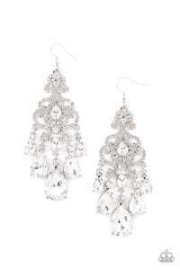 Queen Of All Things Sparkly - White - Paparazzi Accessories -  Item #P5RE-WTXX-485XX Gradually increasing in size, glassy white teardrop gems create a dramatic fringe at the bottom of a decorative silver frame swirling with dainty white rhinestones for a timelessly over-the-top sparkle. Earring attaches to a standard fishhook fitting.  Sold as one pair of earrings.