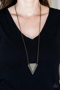 Ancient Arrow - Brass - Paparazzi Accessories -  Stamped and studded in indigenous inspired textures, a stacked triangular pendant swings from the bottom of an elongated brass chain for a trendy tribal look. Features an adjustable clasp closure.  Sold as one individual necklace. Includes one pair of matching earrings.