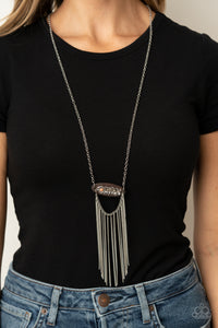 Desert Spirit - Orange - Paparazzi Accessories -  Item #P2SE-OGXX-237XX A fringe of silver chains swings from the bottom of a wooden frame adorned with a shimmery silver feather charm. Dotted with a refreshing orange stone, the whimsical pendant attaches to a lengthened silver chain for a free-spirited finish. Features an adjustable clasp closure.  Sold as one individual necklace. Includes one pair of matching earrings.