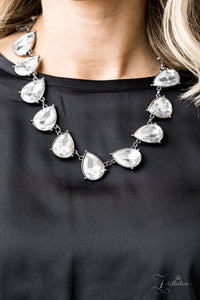 Mystique - 2019 Zi - Paparazzi Accessories -  Featuring sleek gunmetal frames, dramatically oversized white teardrop gems link below the collar in an blinding, statement-making fashion. Features an adjustable clasp closure.  Sold as one individual necklace. Includes one pair of matching earrings.