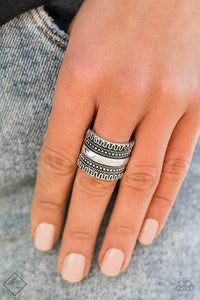 Simply Santa Fe - Sahara Style - Silver Ring - Paparazzi Accessories  A smooth silver bar is flanked by rows of studded and winding textures, creating an unforgettable collision of texture that wraps boldly around the finger. Features a stretchy band for a flexible fit.  Sold as one individual ring.