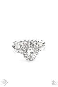 Fiercely 5th Avenue - I Said Yes - white ring - Paparazzi Accessories -  November 2020 Fashion Fix  Item #P4RE-WTXX-403WE A brilliant white rhinestone is encircled by clusters of smaller rhinestones, building into a romantic and timeless design. A delicate band adorned in even more rhinestones sparkles as it wraps around the finger, completing the design. Features a dainty stretchy band for a flexible fit.  Sold as one individual ring.