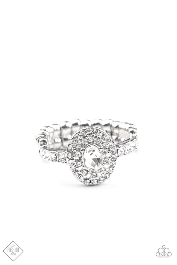 Fiercely 5th Avenue - I Said Yes - white ring - Paparazzi Accessories -  November 2020 Fashion Fix  Item #P4RE-WTXX-403WE A brilliant white rhinestone is encircled by clusters of smaller rhinestones, building into a romantic and timeless design. A delicate band adorned in even more rhinestones sparkles as it wraps around the finger, completing the design. Features a dainty stretchy band for a flexible fit.  Sold as one individual ring.