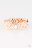 Extra Side Of Elegance - Rose Gold - Paparazzi Accessories Item #P4RE-GDRS-160XX Encrusted in dainty white rhinestones, glistening rose gold ribbons loop away from a dazzling white rhinestone center for a refined look. Features a dainty stretchy band for a flexible fit.  Sold as one individual ring.