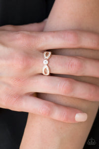 Extra Side Of Elegance - Rose Gold - Paparazzi Accessories Item #P4RE-GDRS-160XX Encrusted in dainty white rhinestones, glistening rose gold ribbons loop away from a dazzling white rhinestone center for a refined look. Features a dainty stretchy band for a flexible fit.  Sold as one individual ring.