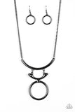 Walk Like An Egyptian - Black - Paparazzi Accessories -   Two glistening gunmetal crescents attach to a large gunmetal hoop, creating a tribal inspired pendant below the collar. Features an adjustable clasp closure.  Sold as one individual necklace. Includes one pair of matching earrings.