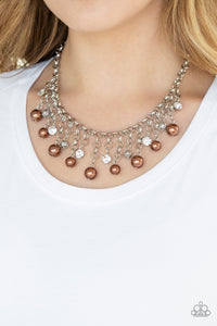 HEIR-headed - Brown - Paparazzi Accessories  A collection of bubbly brown pearls, glittery white rhinestones, and ornate silver beads swing from the bottom of a shimmery silver chain, creating a refined fringe below the collar. Features an adjustable clasp closure.  Sold as one individual necklace. Includes one pair of matching earrings.  #P2RE-BNXX-219XX