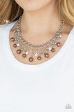 HEIR-headed - Brown - Paparazzi Accessories  A collection of bubbly brown pearls, glittery white rhinestones, and ornate silver beads swing from the bottom of a shimmery silver chain, creating a refined fringe below the collar. Features an adjustable clasp closure.  Sold as one individual necklace. Includes one pair of matching earrings.  #P2RE-BNXX-219XX