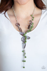 Prismatic Princess - Green - Paparazzi Accessories  Featuring an array of shapes and cuts, a collection of faceted smoky gems link below the collar for a glamorous shimmer. A shimmery silver strand of pearly green beads trickles down one side of the piece, creating a flirtatious extended pendant. Features an adjustable clasp closure.  Sold as one individual necklace. Includes one pair of matching earrings.