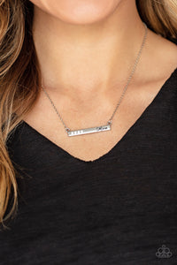 Moms Do It Better - White - Paparazzi Accessories  Dotted in dainty white rhinestones, a dainty silver rectangular frame stamped in the word, "Mom", is suspended by a dainty silver chain below the collar for a charming look. Features an adjustable clasp closure.  Sold as one individual necklace. Includes one pair of matching earrings.