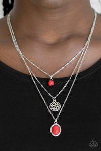 Southern Roots - Red - Paparazzi Accessories  Three shimmery silver chains layer down the chest. A fiery red stone bead swings from the uppermost strand, above a radiant silver tree charm and an ornate red stone pendant for a seasonal look. Features an adjustable clasp closure.  Sold as one individual necklace. Includes one pair of matching earrings.