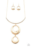 Egyptian Eclipse - Gold - Paparazzi Accessories  Featuring a blinding scratch finish, two beveled gold circular frames swing from the bottom of a bowing gold rod, creating an edgy stacked pendant down the chest. Features an adjustable clasp closure.  Sold as one individual necklace. Includes one pair of matching earrings.