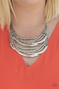 Read Between the VINES - Silver Stamped in sections of vine-like patterns, abstract hammered plates and overlapping silver bars link into an exaggerated pendant below the collar for a statement-making look. Features an adjustable clasp closure.  Sold as one individual necklace. Includes one pair of matching earrings.