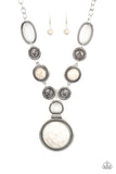 Sedona Drama - White - Paparazzi Accessories - Item #P2SE-WTXX-188XX Featuring floral, textured, and refreshing white stone accents, a collection of unique silver frames link below the collar for a seasonal flair. A dramatically oversized white stone pendant dangles from the bottom for an eye-catching finish. Features an adjustable clasp closure.  Sold as one individual necklace. Includes one pair of matching earrings