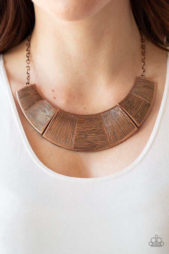 More Roar - Copper - Paparazzi Accessories - Item #P2ST-CPXX-060XX Etched in sections of vertical and horizontal linear textures, glistening antiqued copper plates link together, forming a bold half-moon pendant below the collar. Features an adjustable clasp closure.  Sold as one individual necklace. Includes one pair of matching earrings.