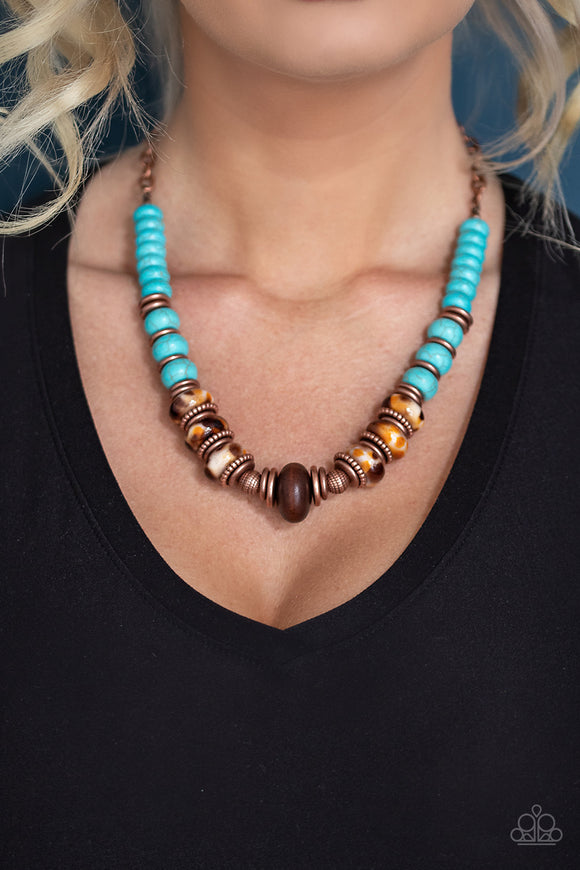 Desert Tranquility - Copper / Blue - Paparazzi Accessories - P2SE-CPXX-123XX An earthy collection of dainty copper accents, rounded turquoise stone beads, and spotted ceramic-like beads are threaded along an invisible wire below the collar. An earthy wooden bead adorns the center, adding an authentic artisan flair to the seasonal display. Features an adjustable clasp closure.  Sold as one individual necklace. Includes one pair of matching earrings.