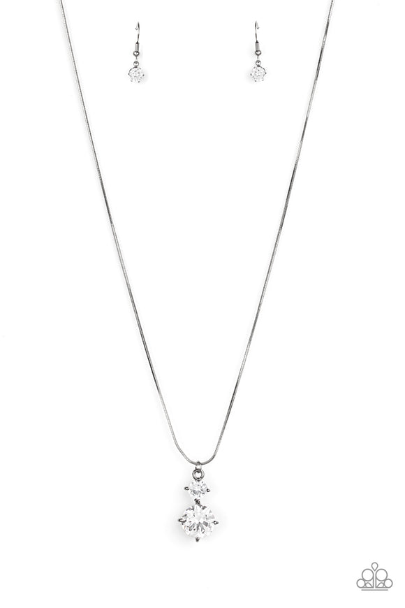 Top Dollar Diva - Black - Paparazzi Accessories -  Item #P2RE-BKXX-414XX Nestled inside classic gunmetal prongs, two oversized white rhinestones slide along a dainty gunmetal snake chain, creating a dramatic pendant below the collar. Features an adjustable clasp closure.  Sold as one individual necklace. Includes one pair of matching earrings.