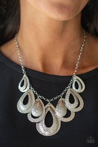 Teardrop Tempest - Silver - Paparazzi Accessories -   Hammered in a blinding textured finish, pairs of mismatched silver teardrops gradually increase in size as they drip below the collar, creating a statement-making fringe. Features an adjustable clasp closure.  You don’t need to break the bank to accessorize your wardrobe!  Its amazing how much 2 or 3 pieces of jewelry can change the look of an outfit.  Sold as one individual necklace. Includes one pair of matching earrings.