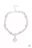 Truly Lovely - Pink - Paparazzi Accessories -   Item #P9WH-PKXX-294FF A pink rhinestone heart charm dances from a strand of white and pink rhinestones, resulting in a flirtatious sparkle around the wrist. Features an adjustable clasp closure.  Sold as one individual bracelet.