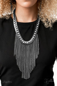 The Alex - 2020 Zi Signature - Paparazzi Accessories  A sassy curtain of mismatched gunmetal chains tapers from the bottom of a dramatic row of glassy white rhinestones that have been delicately fastened to an edgy row of flattened gunmetal chain. The exaggerated fringe cascades down the chest, resulting in a dauntless attitude that demands attention with every swish of the fearless fringe. Features an adjustable clasp closure.  Named after 2020 Rock the Runway winner, Alex M.  Sold as one individual neckla