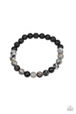 Turned In - Silver - Paparazzi Accessories -  A collection black lava rock beads, smoky stone beads, and ornate silver accents are threaded along a stretchy band around the wrist for a seasonal look.  Sold as one individual stretchy bracelet.