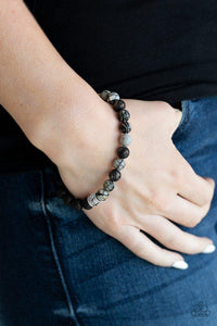 Turned In - Silver - Paparazzi Accessories -  A collection black lava rock beads, smoky stone beads, and ornate silver accents are threaded along a stretchy band around the wrist for a seasonal look.  Sold as one individual stretchy bracelet.