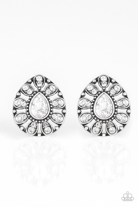 Treasure Retreat - White - Paparazzi Accessories -  P5PO-WTXX-176XX  A teardrop silver frame is encrusted in glittery white rhinestones, creating a sparkling floral frame. Earring attaches to a standard post fitting.  Sold as one pair of post earrings at DeesBlings.com - Affordable Fashion Jewelry that is Lead and Nickel free.