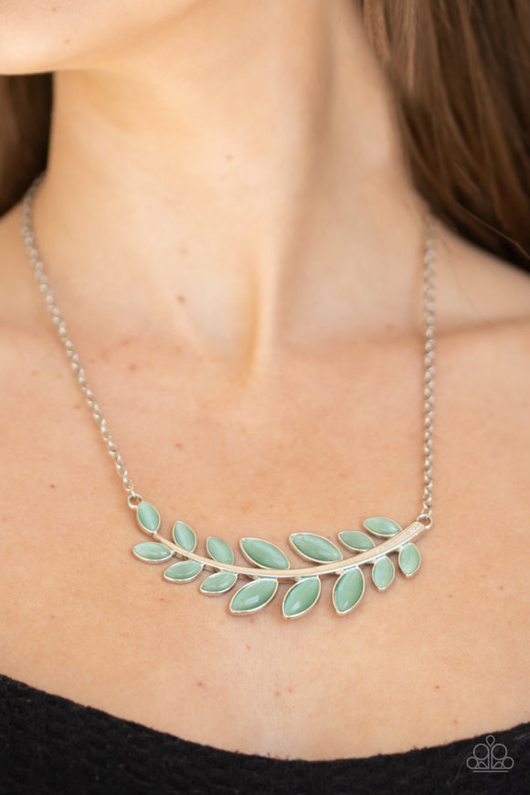 Frosted Foliage - Green - Paparazzi Accessories  Dotted with tranquil green cat's eye stones, a leafy silver branch delicately curves below the collar for a whimsical look. Features an adjustable clasp closure.  Sold as one individual necklace. Includes one pair of matching earrings.